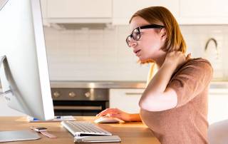 Woman working from home with neck pain